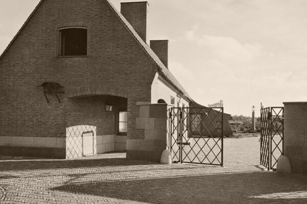 Een zwart-wit foto uit de geschiedenis waarop een zijaanzicht en de toegangspoort van het Landhuis Noorderheide te zien is